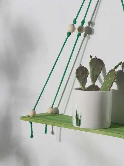 Decorbites™ pink green wooden wall shelf with green macrame, wooden beads, and white pot with prickly pear cactus