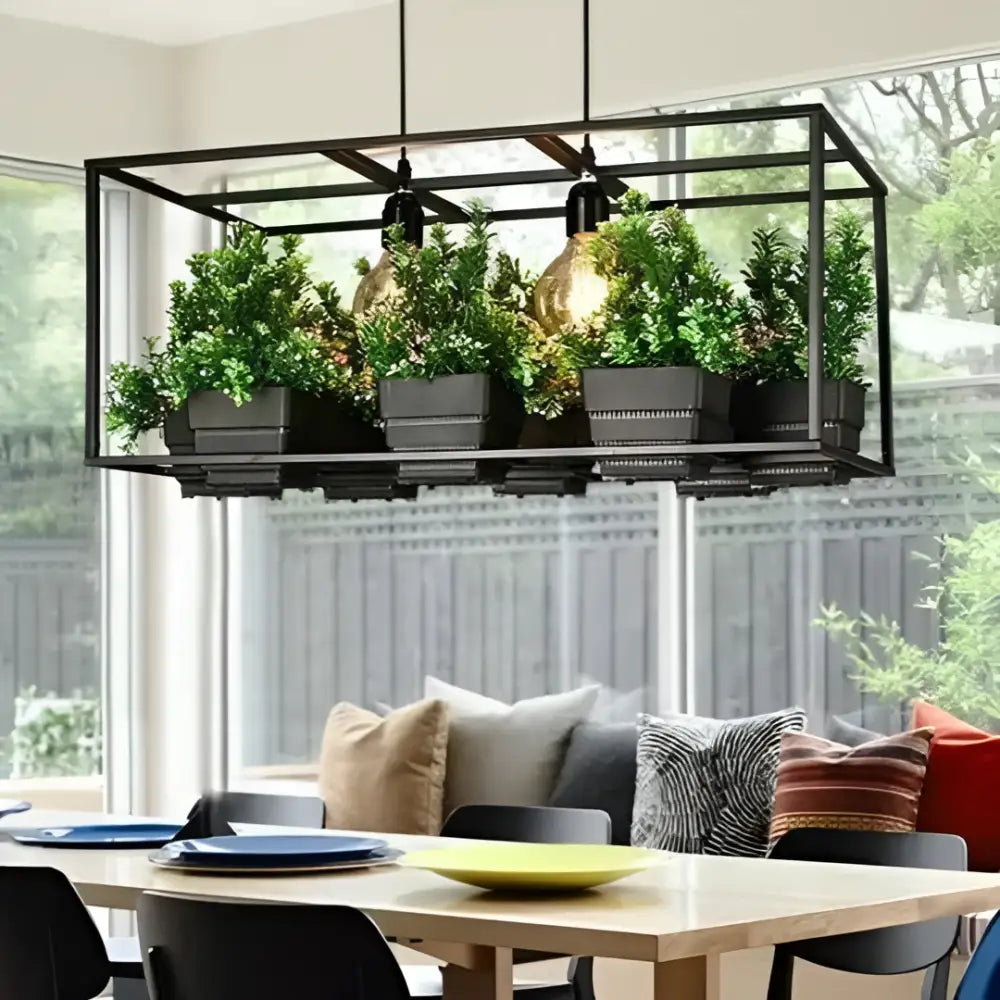 DecorBites™ planter light chandelier with industrial black metal frame housing five green plants in dark gray planters illuminated by warm bulbs