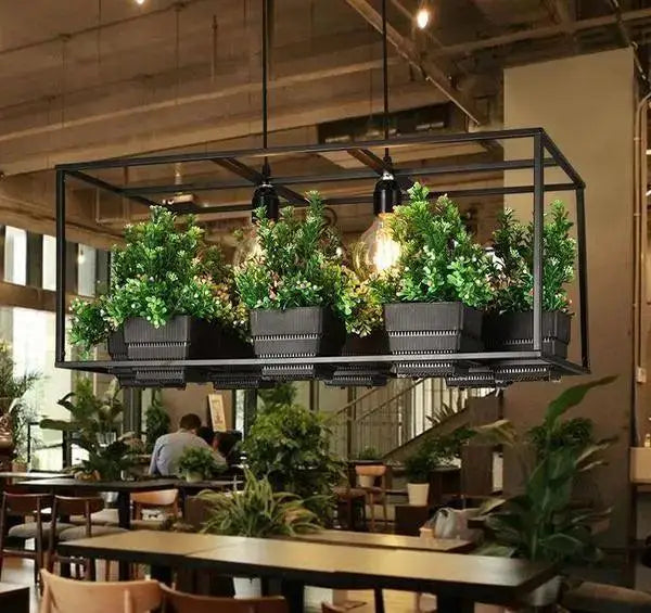 Industrial-style black metal DecorBites™ planter light chandelier with four green plants and exposed filament bulbs