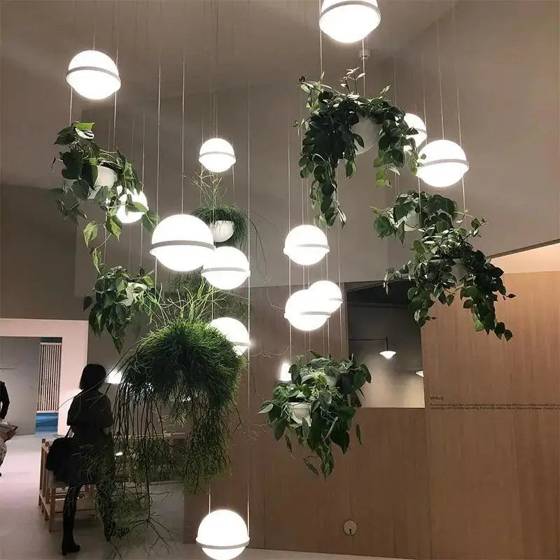 Decorbites™ planter light pendant chandelier featuring suspended spherical white light pendants with green plants in woven baskets
