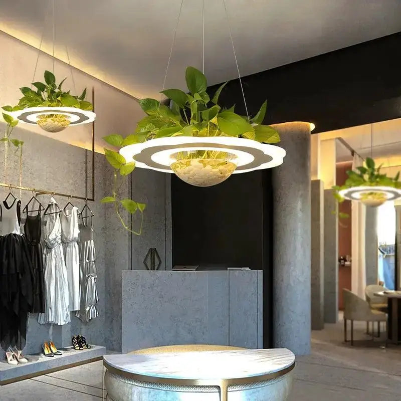Modern circular DecorBites™ planter light table pendant with white led rings and green plants in textured bowl