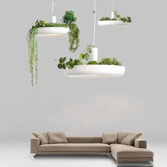 DecorBites™ white circular planter pendant lighting with integrated planters holding lush green foliage