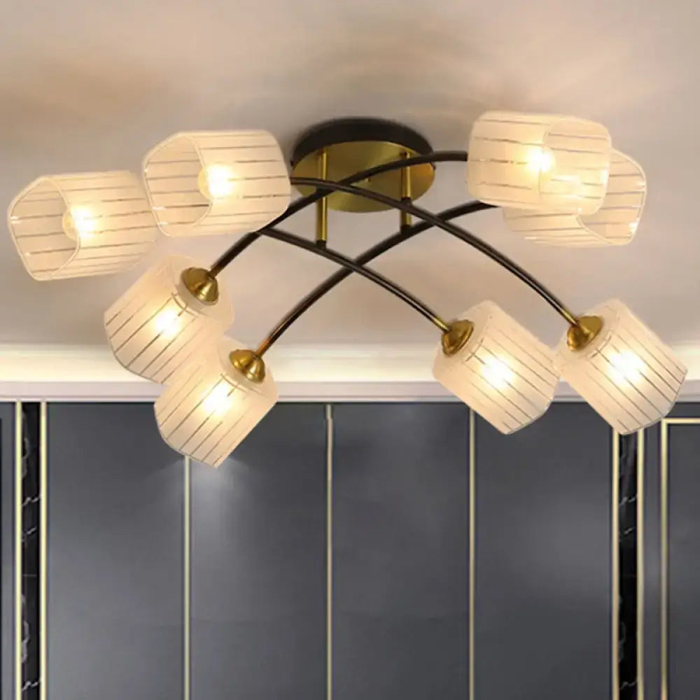 Modern brass semi-flush mount ceiling light with eight warm-toned fabric shades and frosted glass material accents