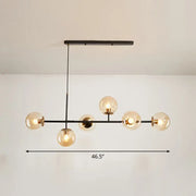 Modern black metal chandelier with six warm-toned glass globe bulbs for dining rooms in grey blue white decor settings
