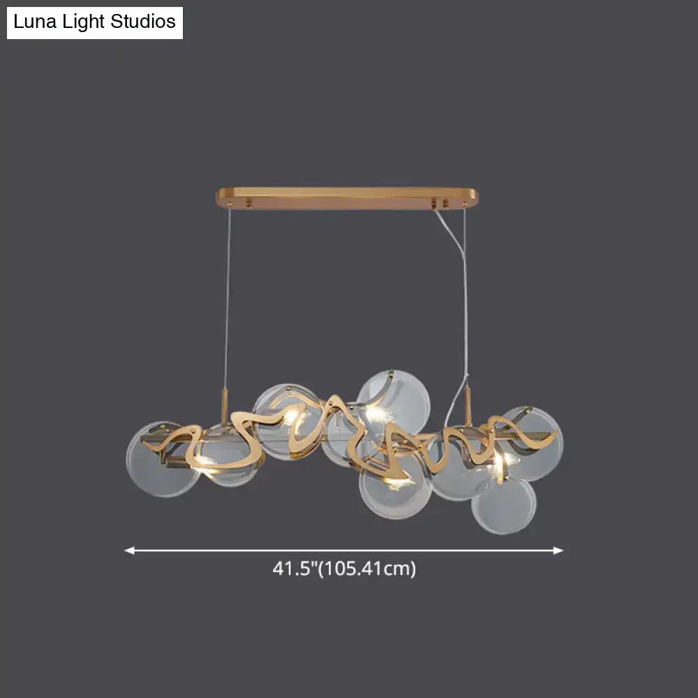 Modern gold-toned DecorBites™ postmodern circle pendant light with clear glass spheres and sculptural metal accents is an elegant light fixture suitable for LED incandescent fluorescent use