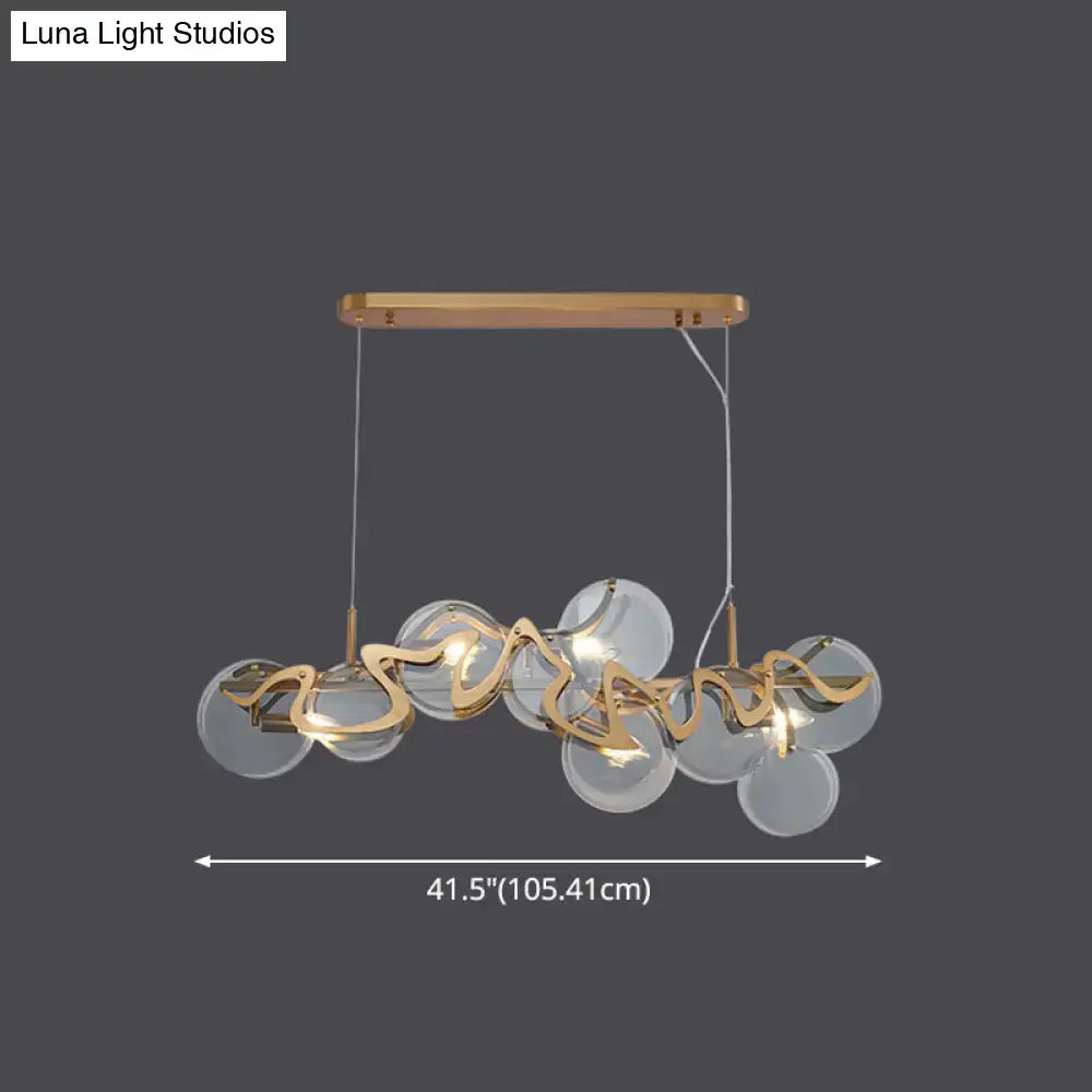 DecorBites™ postmodern circle pendant light with gold-toned metal arms and clear glass spheres LED light fixture