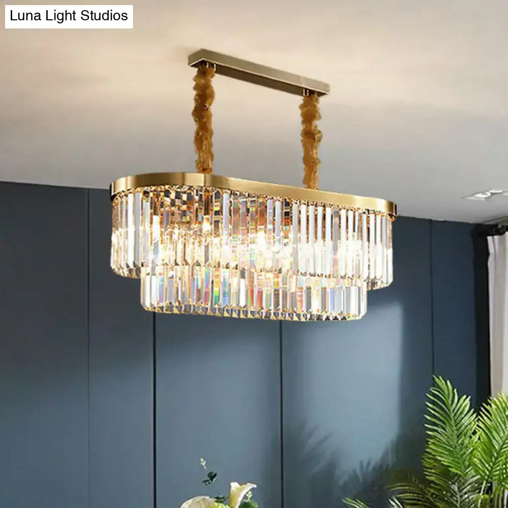 Gold-toned postmodern oblong island light with clear crystal rod tiers and ornate hanging chains for dining room use