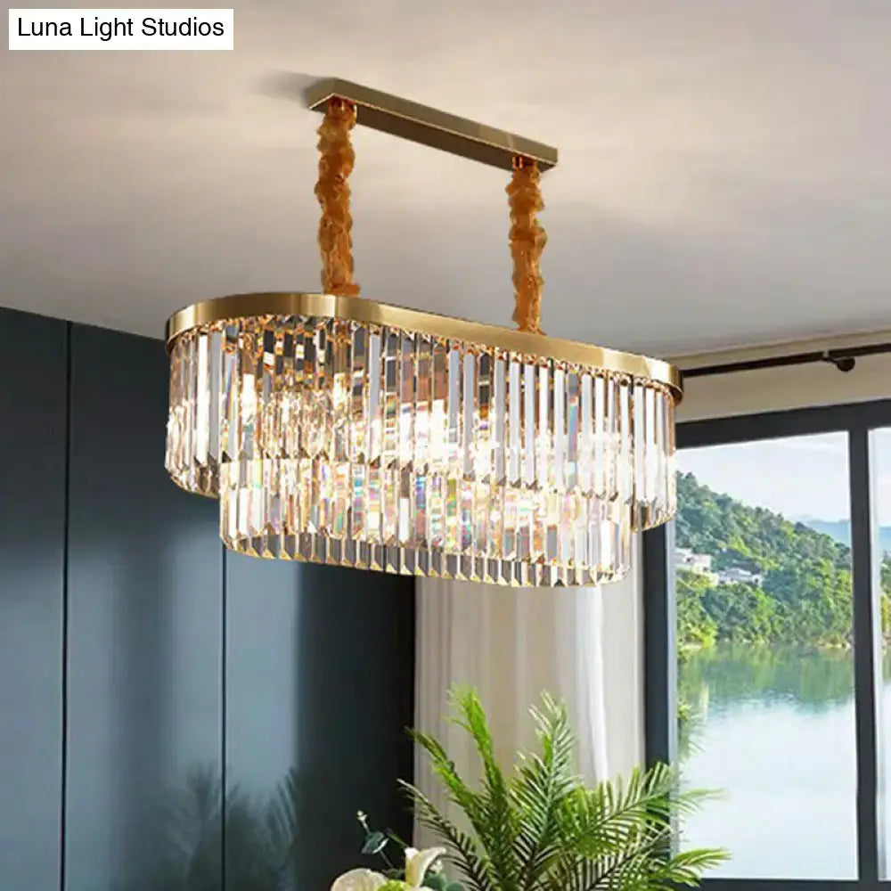 Gold-toned postmodern oblong island light with cascading clear crystal rod pendant in brass finish for dining room
