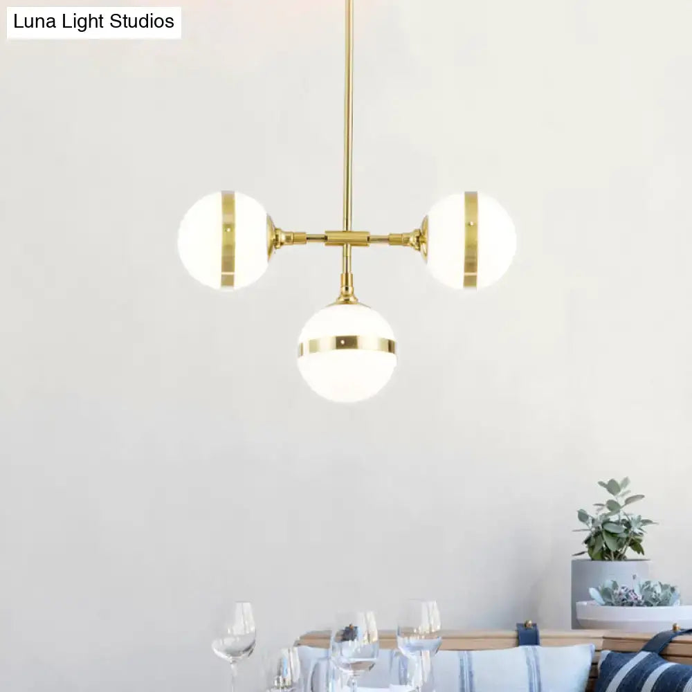 DecorBites postmodern gold branch pendant light with three white ball glass frosted shades and brass accents