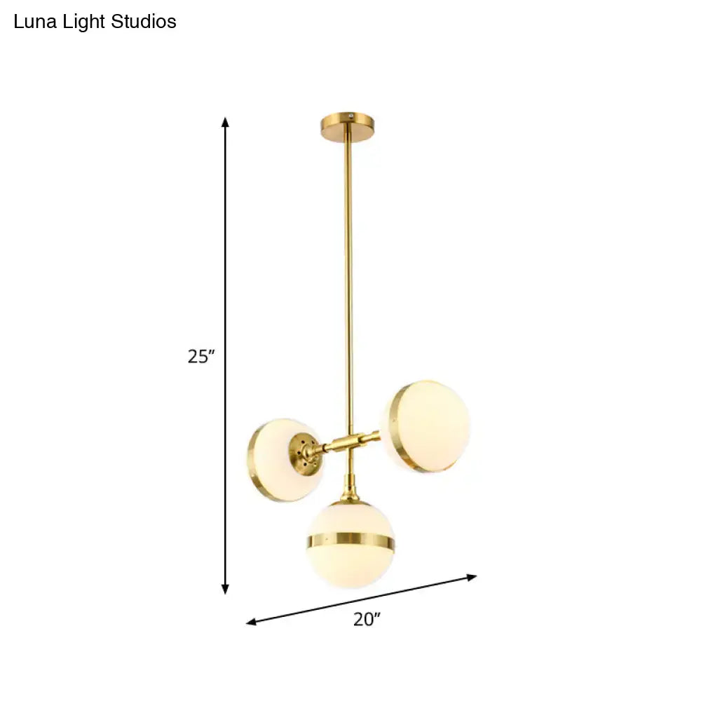 Decorbites postmodern gold branch pendant light with three frosted white ball glass shades in a modern design