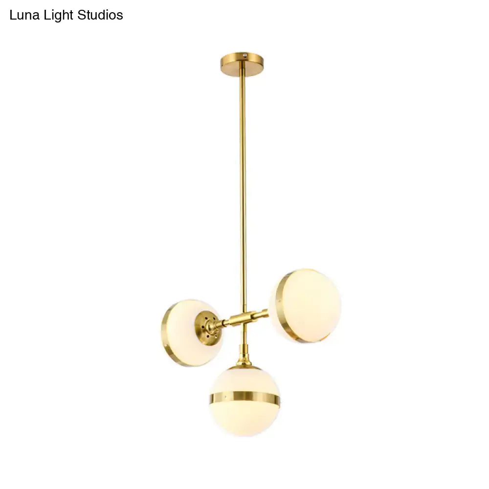 Gold-finished decorbites postmodern pendant light with three white ball glass frosted globe shades suspended from rod