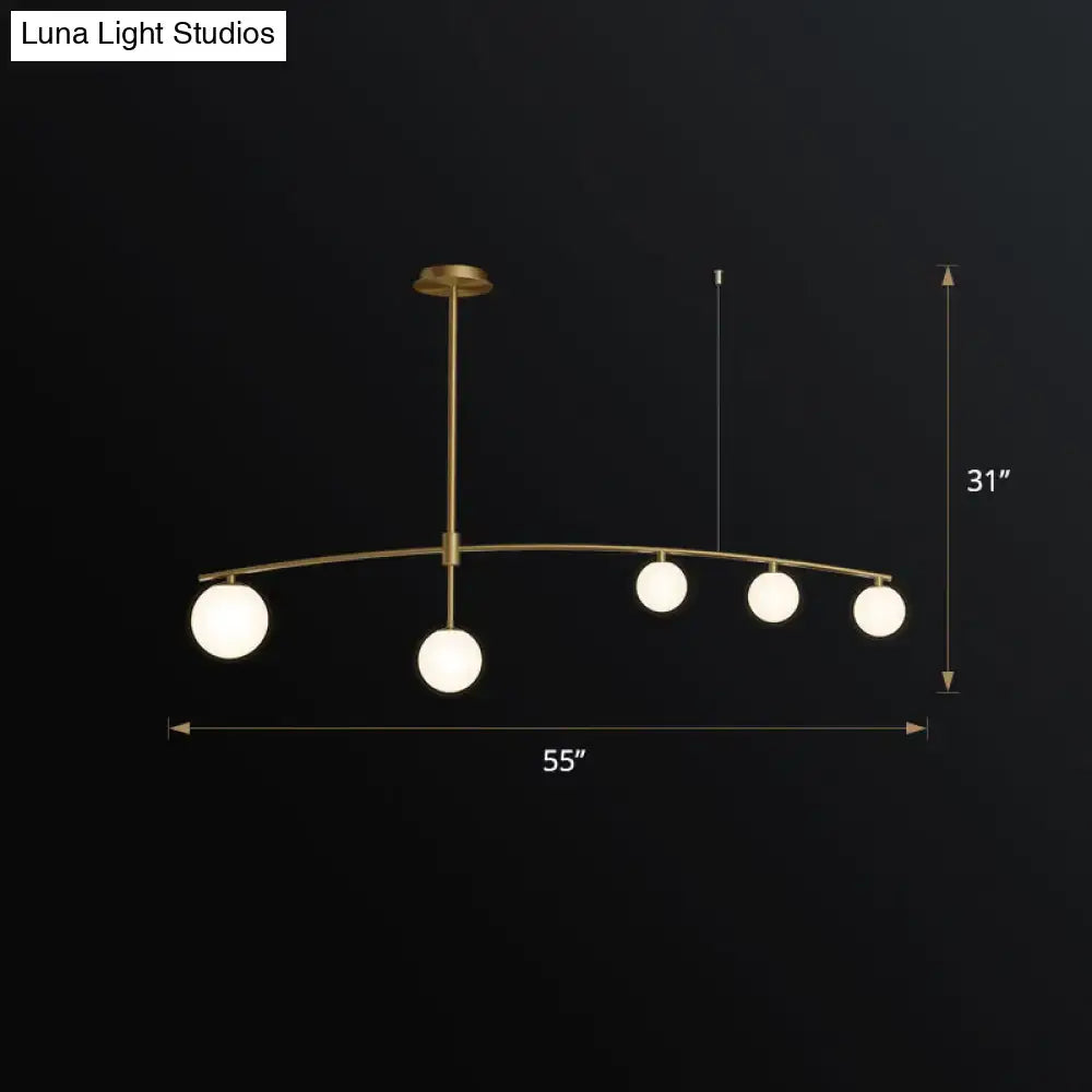 DecorBites postmodern gold island pendant light with five frosted white glass globe hanging lamps in brass finish