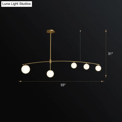 DecorBites postmodern gold island pendant light with five frosted white glass globe hanging lamps in brass finish