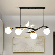 Black wrought iron DecorBites™ island lamp tree with three white glass globes and two ceramic doves on lamp tree branch
