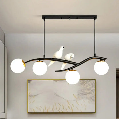 Black wrought iron DecorBites™ island lamp tree with three white glass globes and two ceramic doves on lamp tree branch
