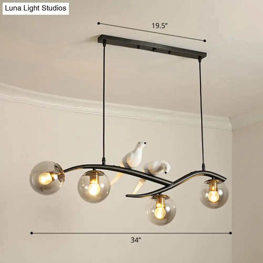 Black metal DecorBites™ island lamp tree branch chandelier with three glass shades and two white bird figurines