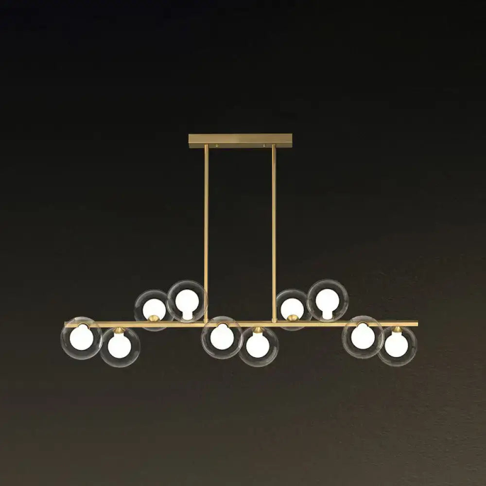 Modern brass light fixture with clear glass globe shades and exposed bulbs for postmodern led island lighting