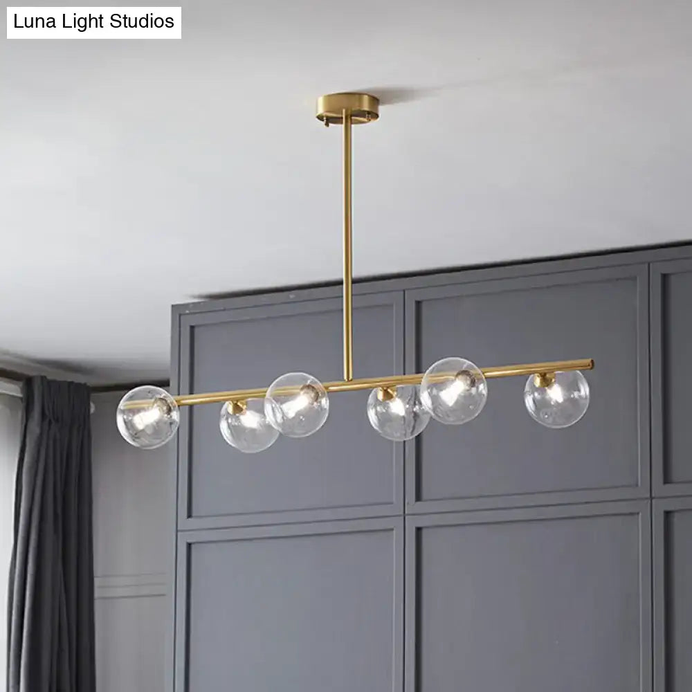 Decorbites postmodern linear island lamp featuring a modern brass pendant light with five clear glass globe bulbs for dining room