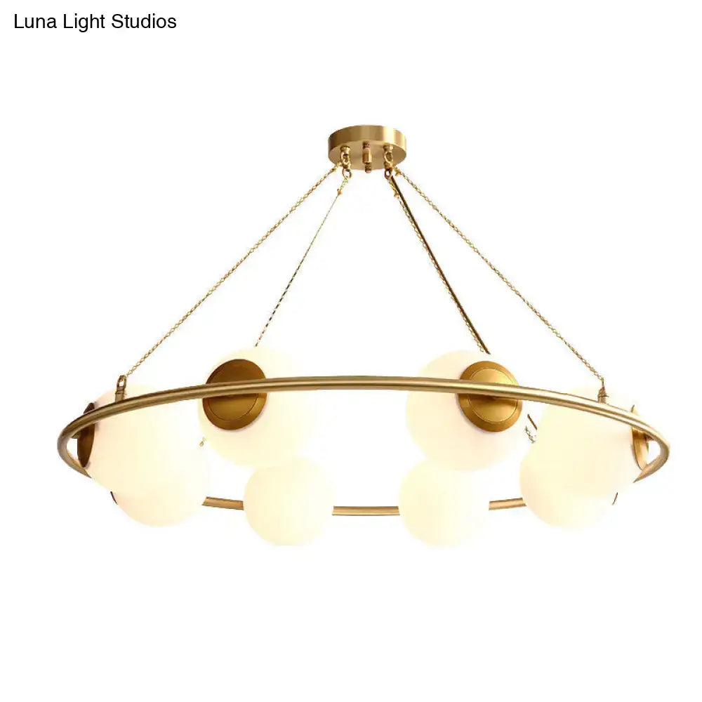 Decorbites™ postmodern circular chandelier light with brass finish and frosted glass globe shades suspended by chains