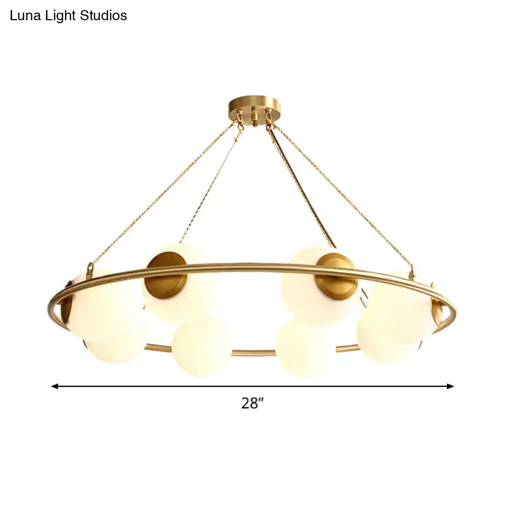 Decorbites postmodern circular chandelier light with brass finish and frosted glass globe shades suspended by chains