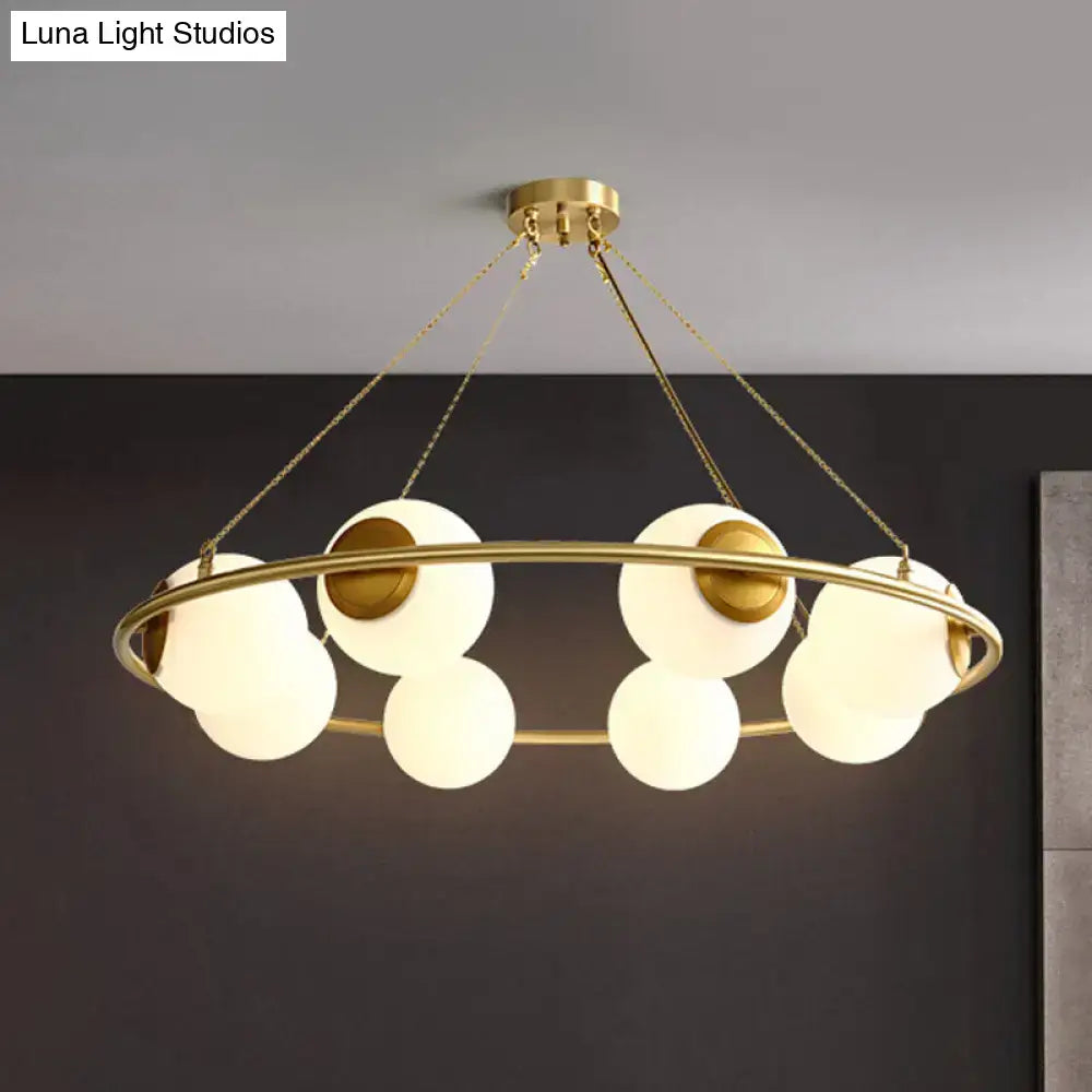 DecorBites™ postmodern circular chandelier light with brass finish and multiple frosted glass globe shades