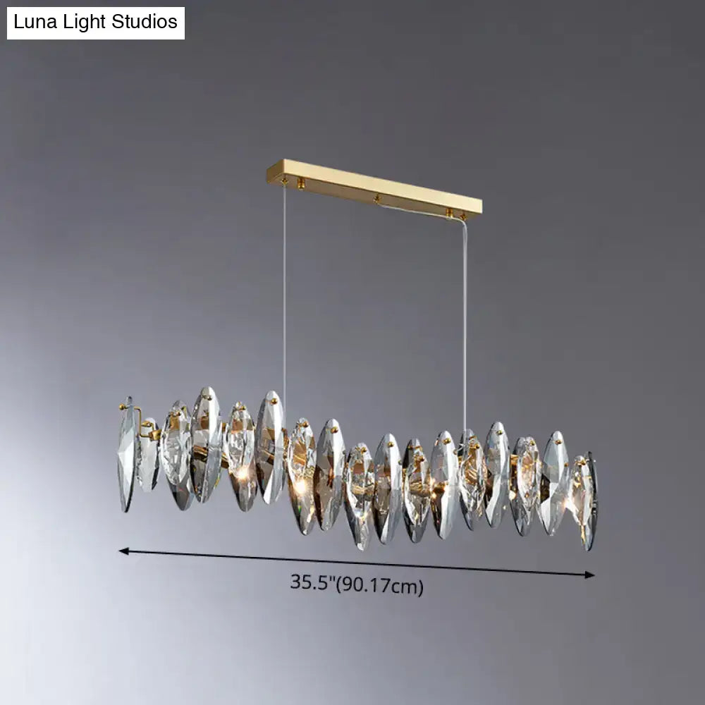A modern rectangular chandelier with gold metal frame and crystal pendants for postmodern smoke grey glass lighting