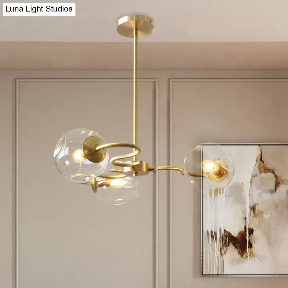 Gold-toned DecorBites™ postmodern semi-flush mount chandelier with three clear glass globes and e12 e14 sockets in brass
