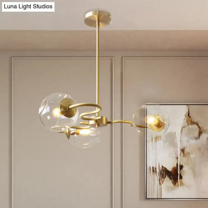 Gold-toned DecorBites™ postmodern semi-flush mount chandelier with three clear glass globes and e12 e14 sockets in brass
