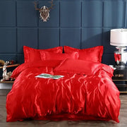 Vibrant red satin bedding set from decorbites premium bedding collection featuring a glossy luxurious duvet cover and bed sheet