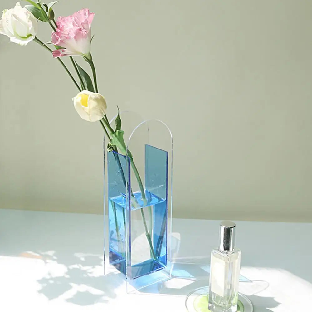 DecorBites™ rainbow color nordic style flower vase transparent blue acrylic with a curved top holding pink and white flowers