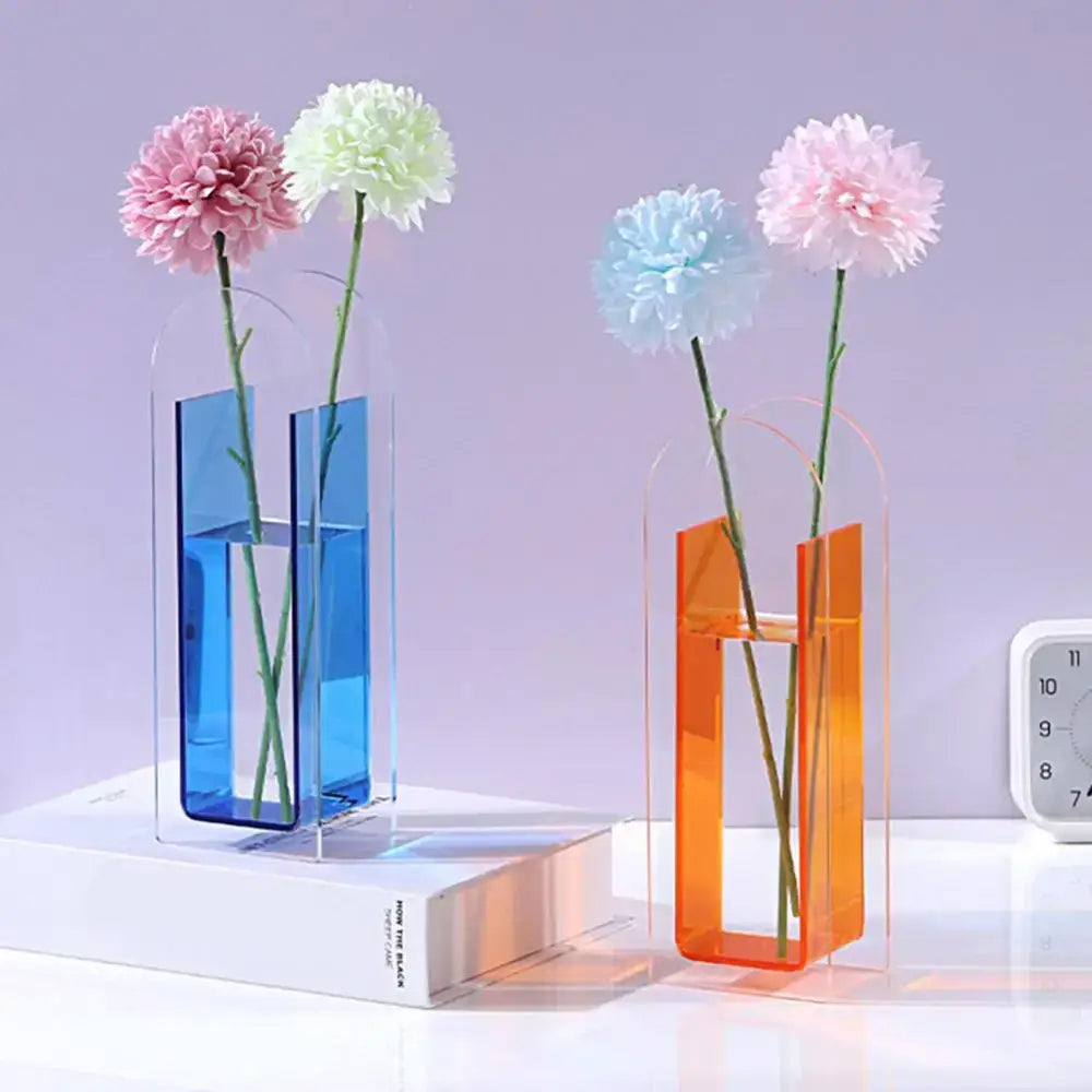 Two translucent rainbow color acrylic flower vases in vibrant blue and warm orange nordic style by DecorBites