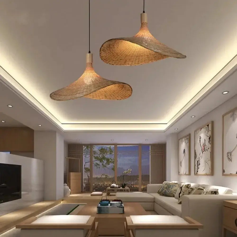 Two elegant light-brown decorbites™ pendant light rattan lamps with dimmable bamboo shades hang from the ceiling