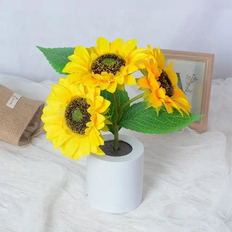 Decorbites™ rechargeable led night light features bright yellow artificial sunflowers in a white pot for bedroom use