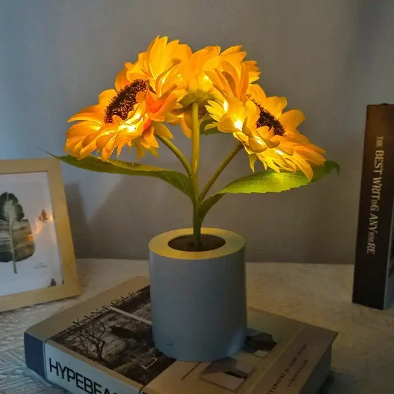 DecorBites™ rechargeable sunflower led night light with glowing yellow petals and light blue cylindrical pot
