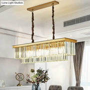 Gold-framed rectangular pendant light with cascading clear glass prisms and twisted bronze chains for living room black gold decor