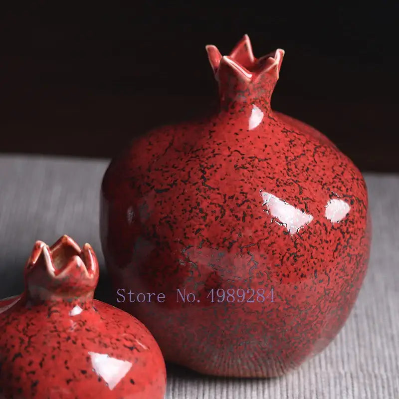 Vibrant red pomegranate ceramic vase with glossy glaze and speckled black texture for modern home decor by DecorBites™