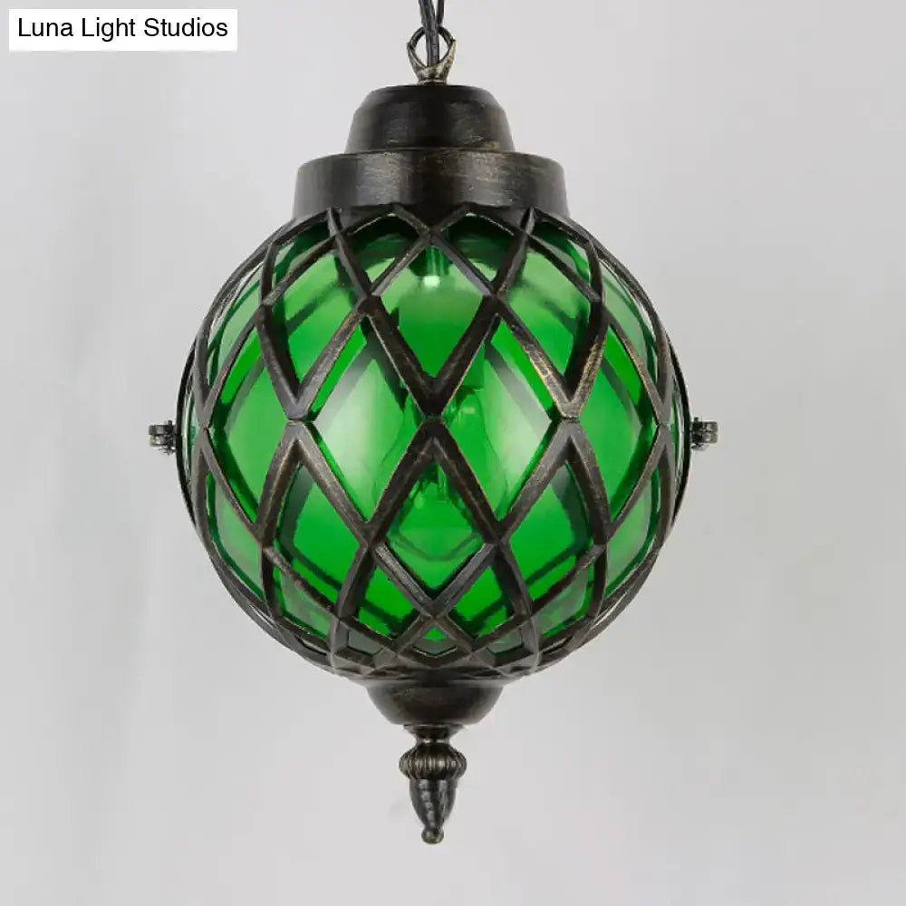 Green glass globe pendant light with dark metal lattice design from decorbites amber green purple restaurant lighting