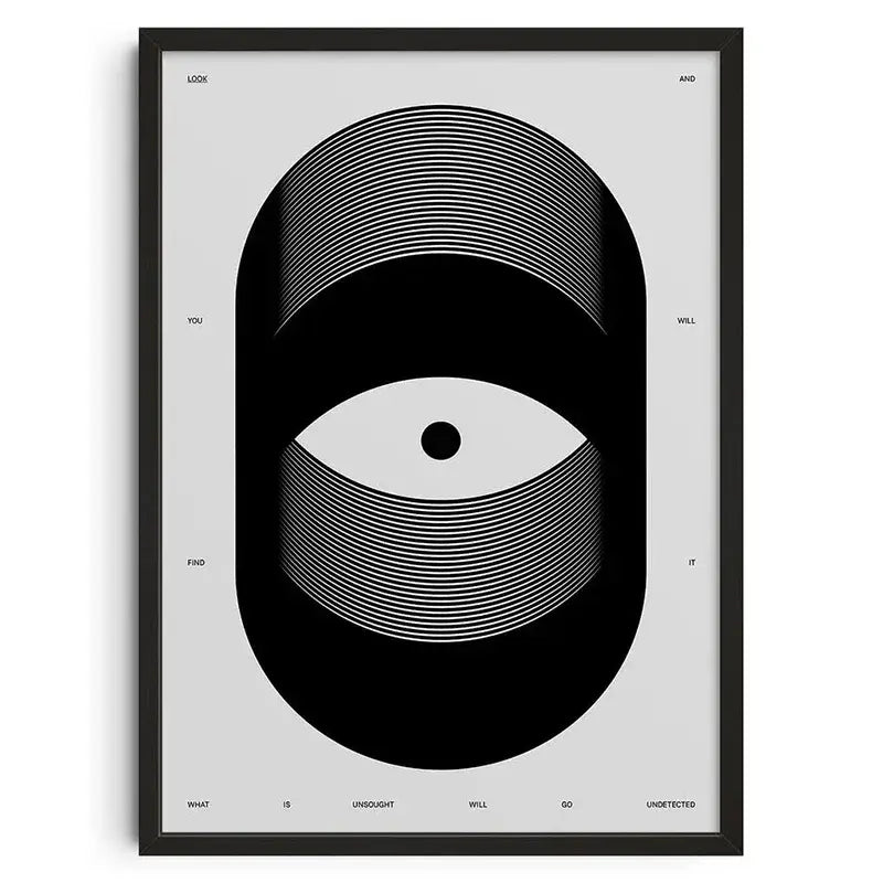 Black framed canvas print featuring a retro abstract stylized eye design with text on a gray background wall art by decorbites