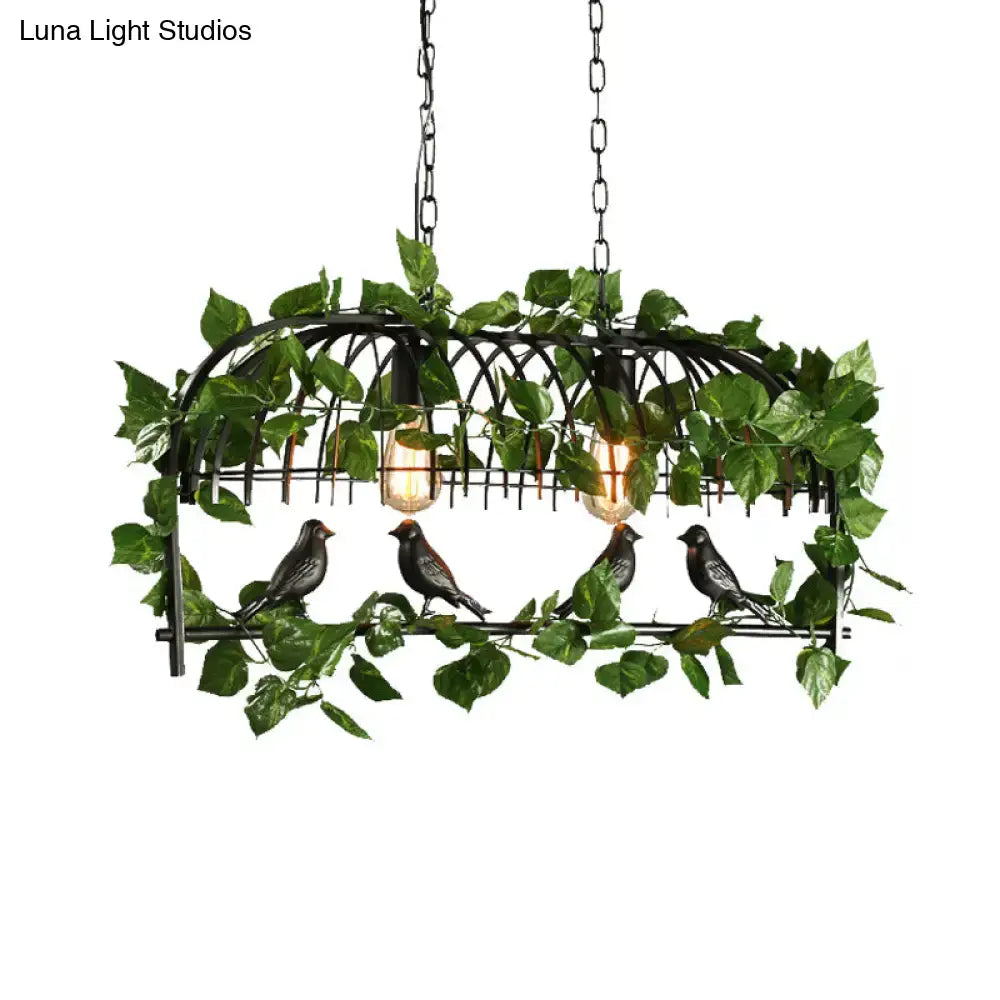 Black wrought iron retro birdcage island light fixture with artificial green vines and four bird figurines
