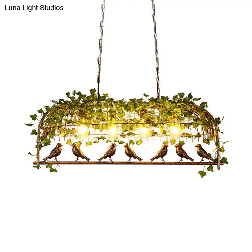 Bronze-colored metal retro birdcage island light fixture with ivy vines and warm glowing bulbs for ceiling use