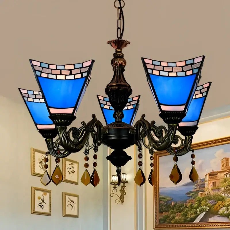 DecorBites retro geometric stained glass chandelier with blue yellow glass, ornate metal arms, and amber crystal pendants