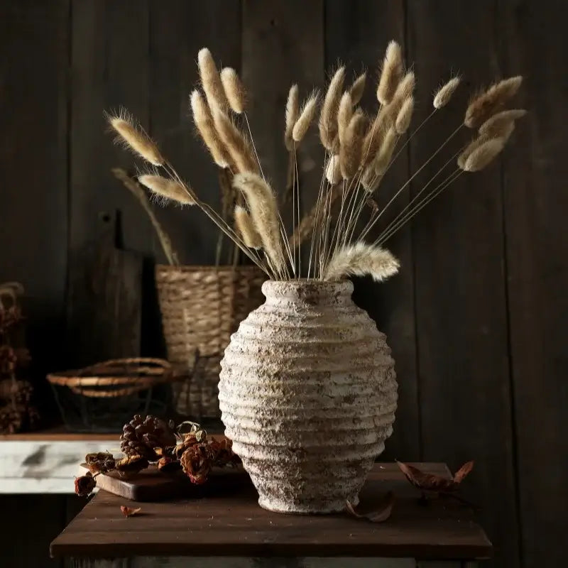 DecorBites™ retro handmade white ceramic vase with horizontal ridges holding dried beige bunny tail grass bouquet