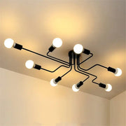 Black metal DecorBites™ retro industrial wrought iron ceiling light with eight exposed bulbs in modern branching design