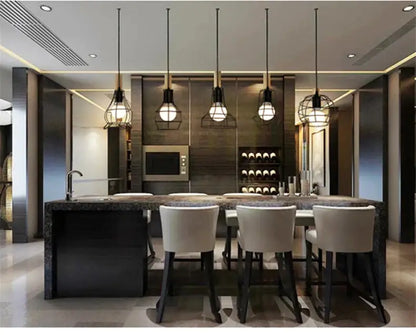 Decorbites™ retro iron art pendant light features black iron art cages with warm bulbs above a modern kitchen island