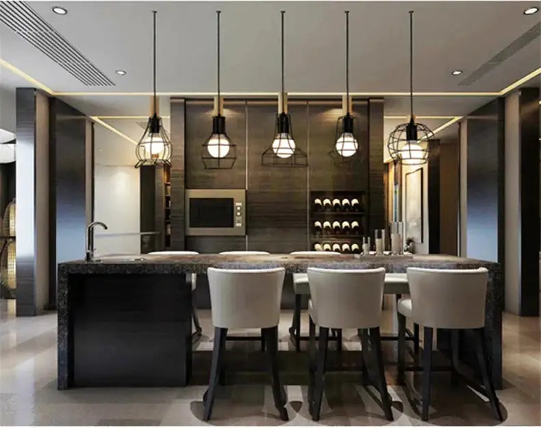 Decorbites™ retro iron art pendant light features black iron art cages with warm bulbs above a modern kitchen island