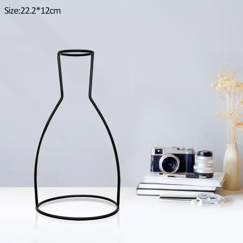 Black wireframe DecorBites™ retro iron flower vase with sleek minimalist design and rounded base for home and garden