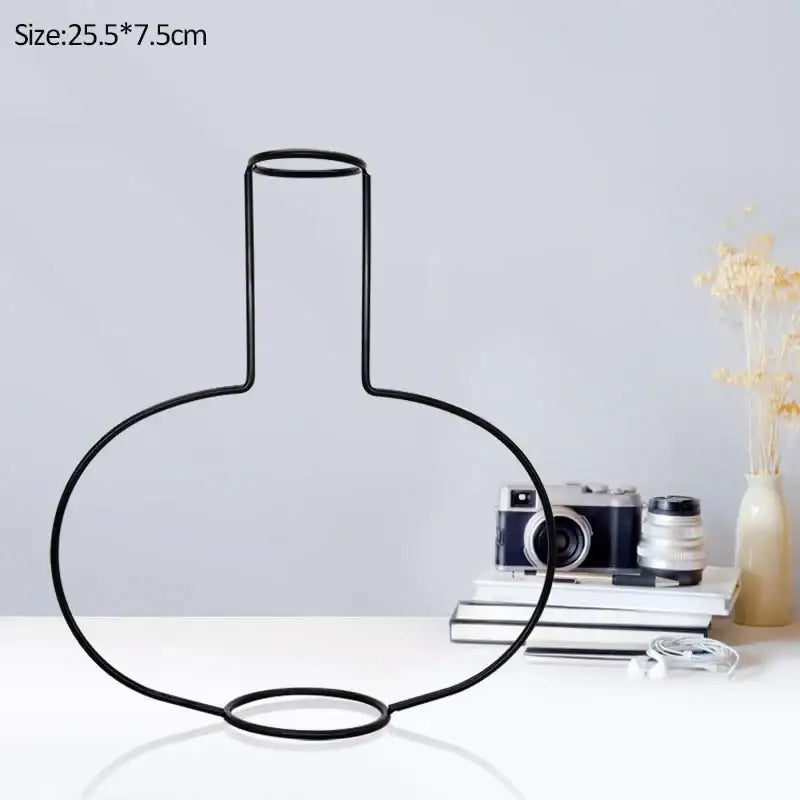 Black wireframe retro iron flower vase with a sleek minimalist design and rounded bulbous base for home decor