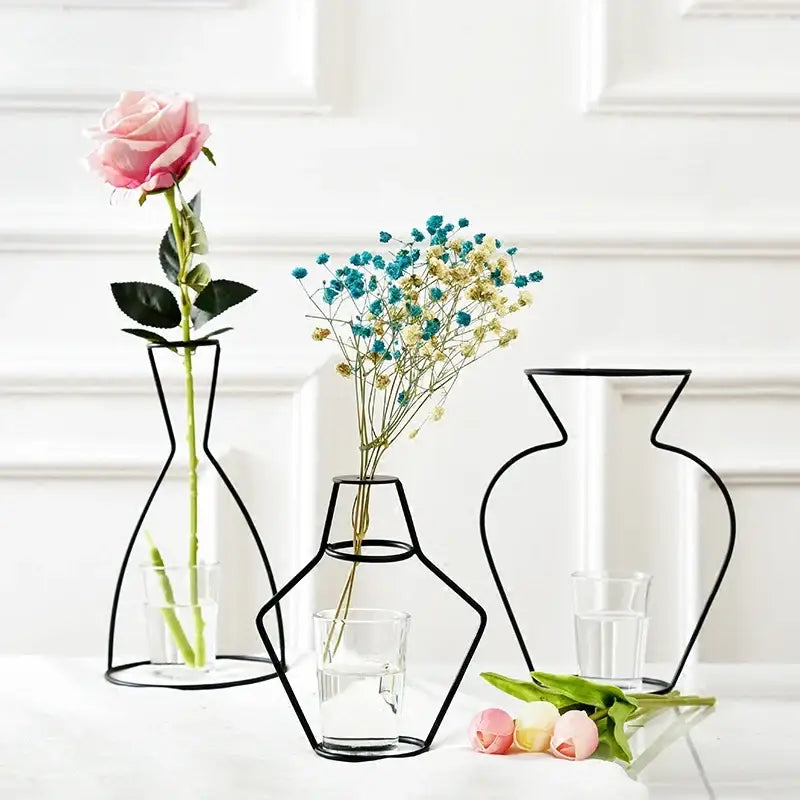 Three minimalist black retro iron flower vases with wireframe design and clear glass bases for home and garden decor