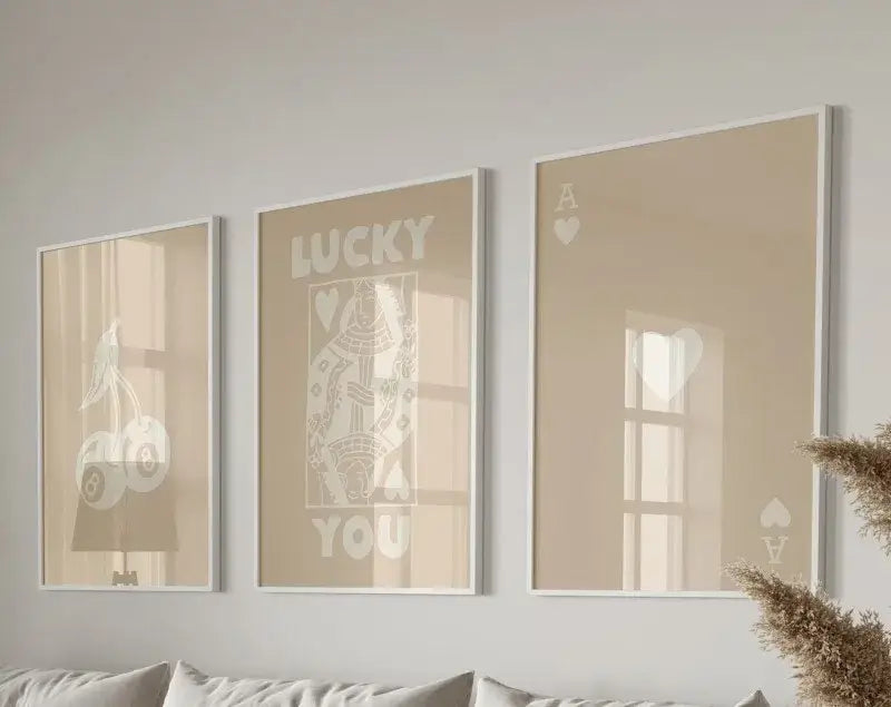 Set of three beige-framed hearts canvas posters set featuring minimalist white designs and lucky you text by decorbites