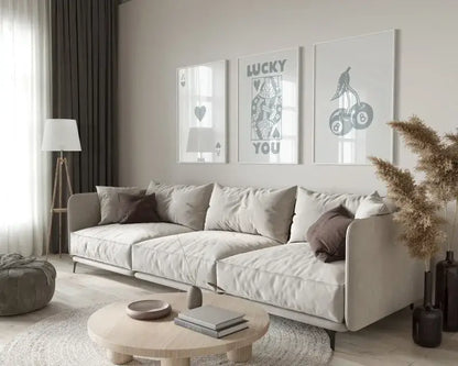 Beige upholstered sectional sofa with soft rounded armrests paired with decorbites retro queen of hearts wall art set